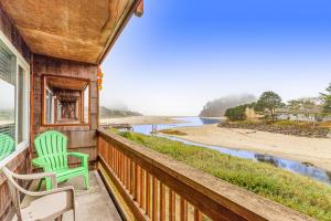 a porch with two chairs and a view of the beach at Proposal Rock View in Neskowin
