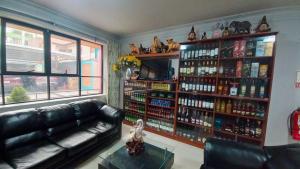 a living room with a couch and a shelf of alcohol at Hotel Monte Roraima in Huancayo