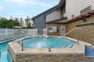 a swimming pool in a house with a building at Best Western Plus Oak Harbor Hotel and Conference Center in Oak Harbor