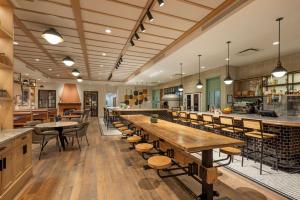 a restaurant with wooden tables and chairs and a bar at Best Western Plus Baker Street Inn in Nelson