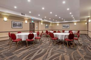 una sala de conferencias con mesas y sillas rojas en Best Western Plus Baker Street Inn en Nelson