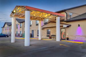 a gas station with awning in front of a building at Motel 6-Percival, IA in Percival