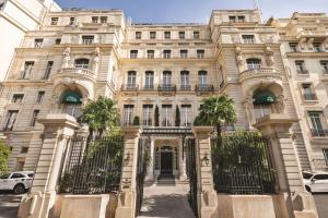 a large building with palm trees in front of it at Shangri-La Paris in Paris