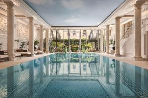 a swimming pool in a building with columns at Shangri-La Paris in Paris