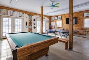 a room with a pool table and a tv at Hillside Estate - 14 Acre Waterfront Log home on Lake Champlain in Grand Isle