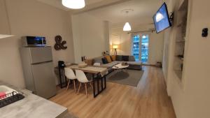 a kitchen and living room with a table and a couch at The PM - in the heart of Thessaloniki in Thessaloniki