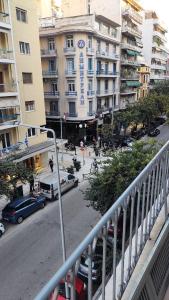 a city street with cars parked in front of buildings at The PM - in the heart of Thessaloniki in Thessaloniki