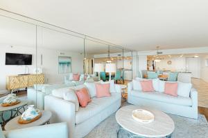 a living room with two couches and a table at Breakers East 604 in Destin