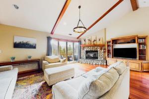 a living room with a couch and a fireplace at Deer Mountain in Lake Arrowhead