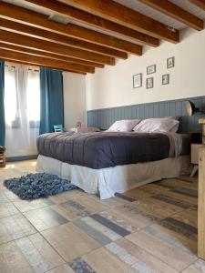 a bedroom with a large bed in a room at Mountain House departamentos de montaña in Lago Meliquina