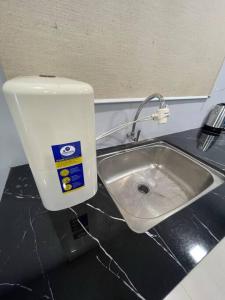 a bathroom with a sink and a water tank at Dalamanda 3Pax Sunway Velocity Balcony CItyView in Kuala Lumpur