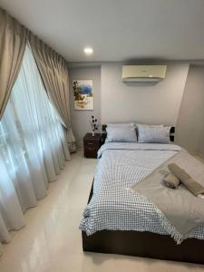 a bedroom with two beds in a room with windows at Dalamanda 3Pax Sunway Velocity Balcony CItyView in Kuala Lumpur