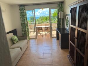 a living room with a couch and a table at Ocean dream in Sainte-Anne