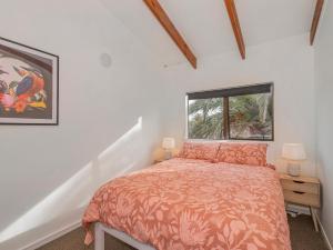 a bedroom with a bed and a window at Surfscape - Whitianga Holiday Home in Whitianga