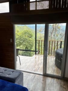 a room with a sliding glass door to a deck at Glamping Bellavista in La Vega