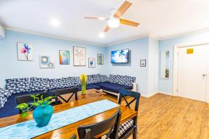 a dining room with a table and a couch at Sunset Cottage at Viking Hill in Nassau