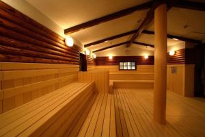 a large empty sauna with wooden floors and lights at Spa World HOTEL&RESORT in Osaka