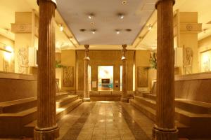 a hall with columns in a building at Spa World HOTEL&RESORT in Osaka
