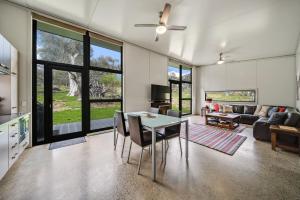 a living room with a table and a couch at Ecocrackenback 19 Sustainable chalet close to the slopes in Crackenback