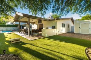 a house with a large backyard with a lawn at Private Pool & Spa ** Steps to Old Town ** Sanatized in Scottsdale