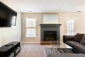 a living room with a couch and a fireplace at Discounted Gorgeous 2 bed/ 2.5 bathroom Townhome in Riverdale