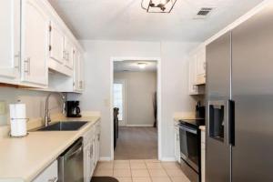 a kitchen with white cabinets and a stainless steel refrigerator at Discounted Gorgeous 2 bed/ 2.5 bathroom Townhome in Riverdale