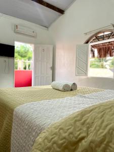 a bedroom with a bed with two pillows on it at Pousada Kawaii in Arraial d'Ajuda