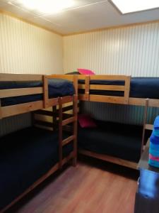 a room with three bunk beds in it at Cabañas Avenida España in Punta Arenas
