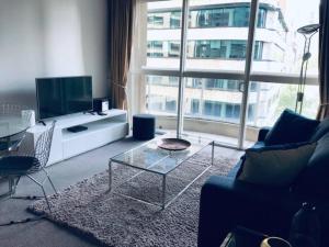 a living room with a couch and a tv at Fantastic location - apartment in Sydney CBD BON02617 in Sydney