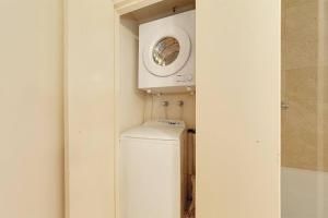 a washer and dryer in a bathroom with a window at Fantastic location - apartment in Sydney CBD BON02617 in Sydney