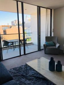 a living room with a couch and a table at Stunning Apartment in Neutral Bay GRO17401 in Sydney