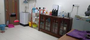 a cluttered kitchen with a counter and a cabinet in a room at Rawyna homestay segamat in Segamat