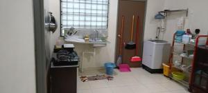 a small kitchen with a sink and a counter at Rawyna homestay segamat in Segamat