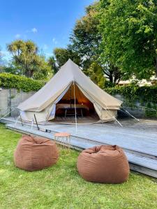 a tent with two bean bags in the grass at Te Anau Lakefront Backpackers in Te Anau