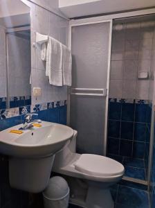 a bathroom with a sink and a toilet and a shower at Algo Mas Hotel - Santa Beatriz in Cusco