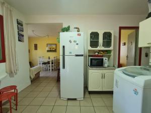una cucina con frigorifero e forno a microonde di Casa Praia da Barra, Garopaba a Garopaba
