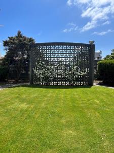 a gate in a yard with green grass at Bings Motel in Blenheim