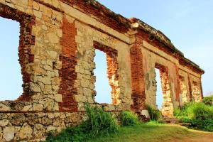 un antiguo edificio de ladrillo con dos arcos en un campo en Summer all year! Oceanfront with Pool A/C, en Aguadilla