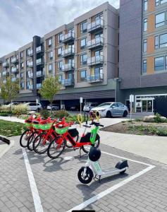 a group of bikes parked in a parking lot at Lovely condo located close to downtown/waterfront! in Kelowna