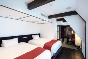 Postel nebo postele na pokoji v ubytování EN Hotel Shibuya
