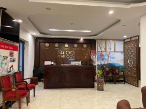 a restaurant with a waiting room with chairs and a counter at Sapa Melody Hotel in Sapa