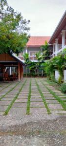 a stone walkway in front of a building at Pongkham Residence in Luang Prabang