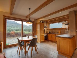 a kitchen with a table and chairs and a large window at Appartement Samoëns, 3 pièces, 4 personnes - FR-1-642-77 in Samoëns