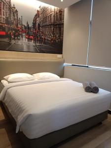 a bed in a room with a picture on the wall at Odua Golden Mansyur Medan in Medan