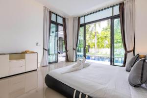 a bedroom with a large bed and a large window at 3 Bedroom Pool Villa BL2 in Hua Hin +72 photos