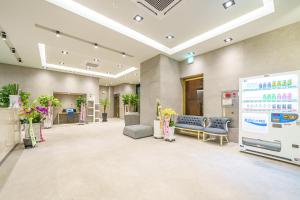 an office lobby with a large screen in the middle at Browndot Hotel Sangmu in Gwangju