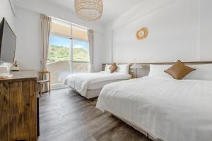 מיטה או מיטות בחדר ב-H& Yu Krung Style Inn