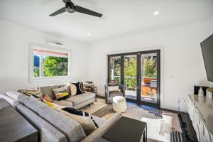 a living room with a couch and a ceiling fan at Luxury River Home - Pets Stay Free in Monte Rio