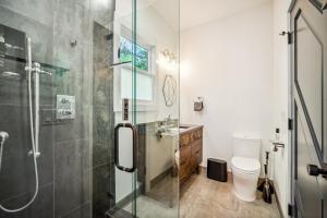 a bathroom with a shower and a toilet at Luxury River Home - Pets Stay Free in Monte Rio +22 photos