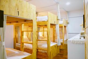 a room with bunk beds in a hostel at Home Story Hostel Chiang Mai in Chiang Mai